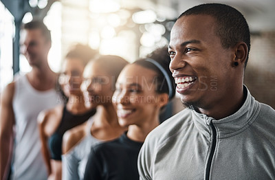 Buy stock photo Shot of a group of young people standing together in a line at the gym