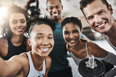 Buy stock photo Shot of a group of young people taking a selfie together during their workout in a gym