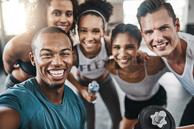 Buy stock photo Shot of a group of young people taking a selfie together during their workout in a gym