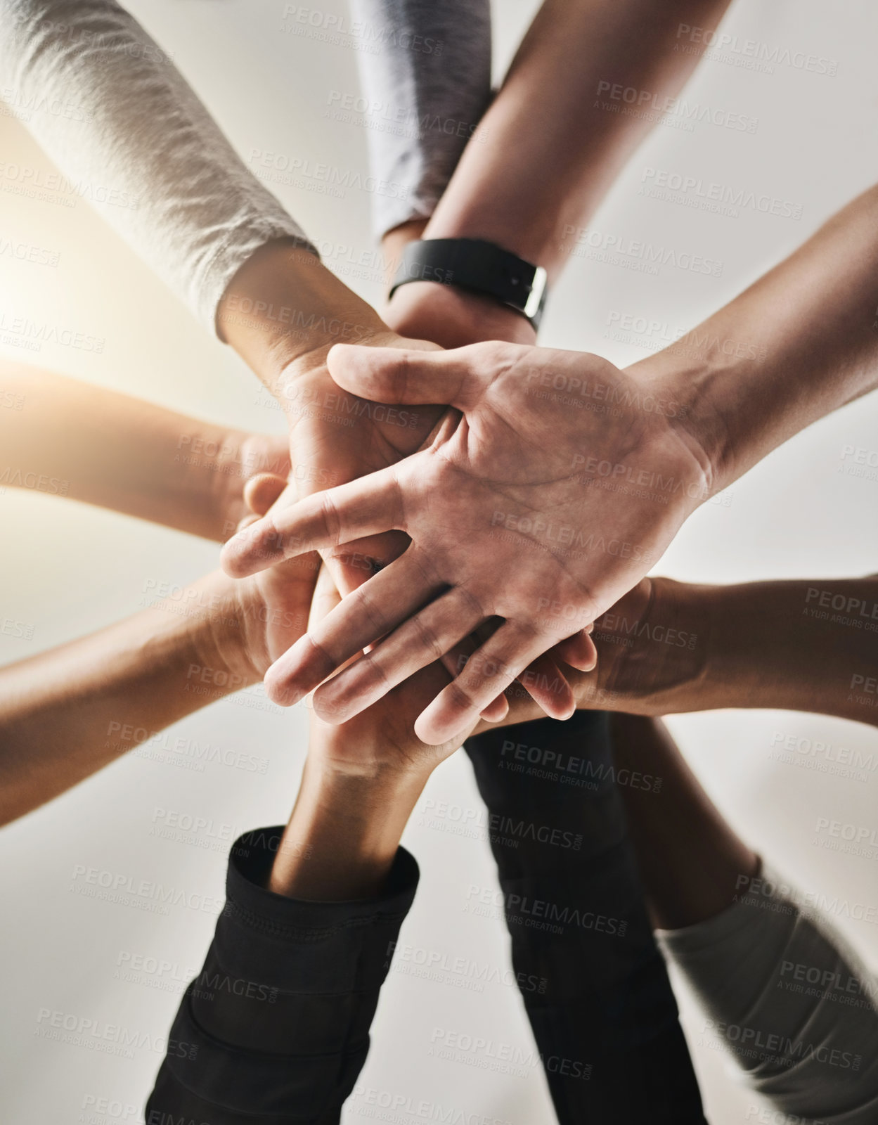 Buy stock photo Cropped shot of a group of people joining their hands together in solidarity at a gym