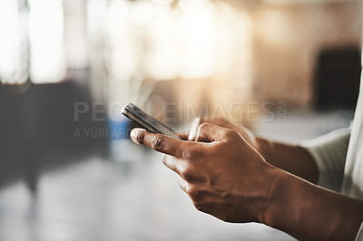 Buy stock photo Shot of an unrecognizable man using a mobile phone in a gym