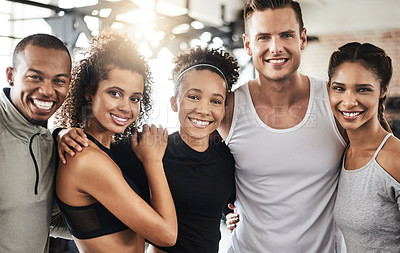 Buy stock photo Shot of a group of happy young people working out together in a gym