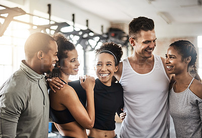 Buy stock photo Shot of a group of happy young people working out together in a gym