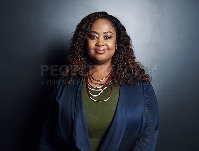 Buy stock photo Cropped portrait of an attractive young businesswoman standing in the studio against a dark background