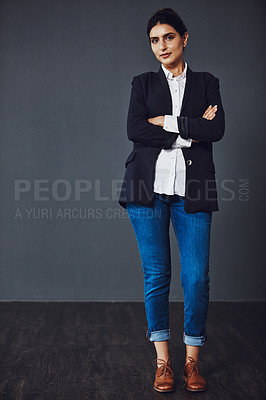 Buy stock photo Studio shot of an attractive and confident young businesswoman posing against a dark background