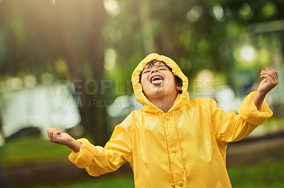 Buy stock photo Cropped shot of an adorable little boy in the rain outside