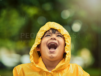 Buy stock photo Cropped shot of an adorable little boy in the rain outside