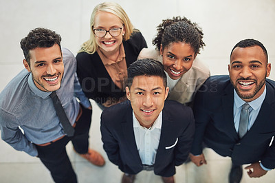 Buy stock photo High angle portrait of a group of cheerful young businesspeople  standing together in the office during the day