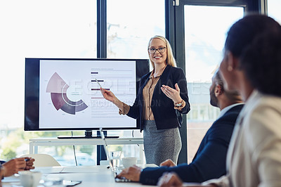 Buy stock photo Shot of a young businesswoman delivering a presentation to her colleagues in the boardroom of a modern office