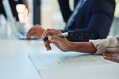 Buy stock photo Cropped shot of a businesswoman going through paperwork during a meeting in the boardroom of a modern office
