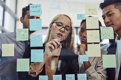 Buy stock photo Business, people and writing on glass with sticky note in office, corporate employees and brainstorming together. Strategy, planning and idea or company collaboration project, teamwork and discussion