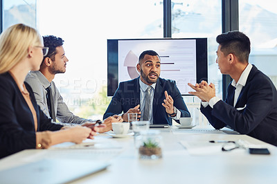 Buy stock photo Shot of a group of young businesspeople having a meeting in the boardroom of a modern office