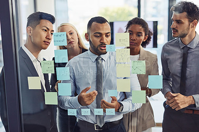 Buy stock photo Shot of a group of young businesspeople having a brainstorming session together in a modern office