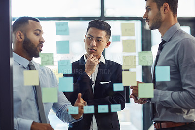 Buy stock photo Shot of a group of young businesspeople having a brainstorming session together in a modern office