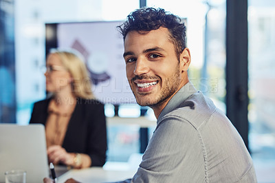 Buy stock photo Portrait of a confident young businessman having a meeting with colleagues in the boardroom of a modern office