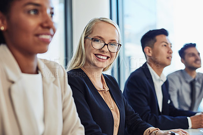 Buy stock photo Portrait of a confident young businesswoman having a meeting with colleagues in the boardroom of a modern office