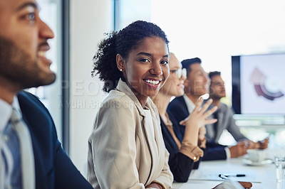 Buy stock photo Portrait of a confident young businesswoman having a meeting with colleagues in the boardroom of a modern office