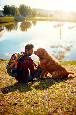 Buy stock photo Nature, dog and man in park, bonding and relax in forest with backpack, golden retriever and lake. Outdoor, pet and person with smile for trip, travel and vacation with animal, water and together