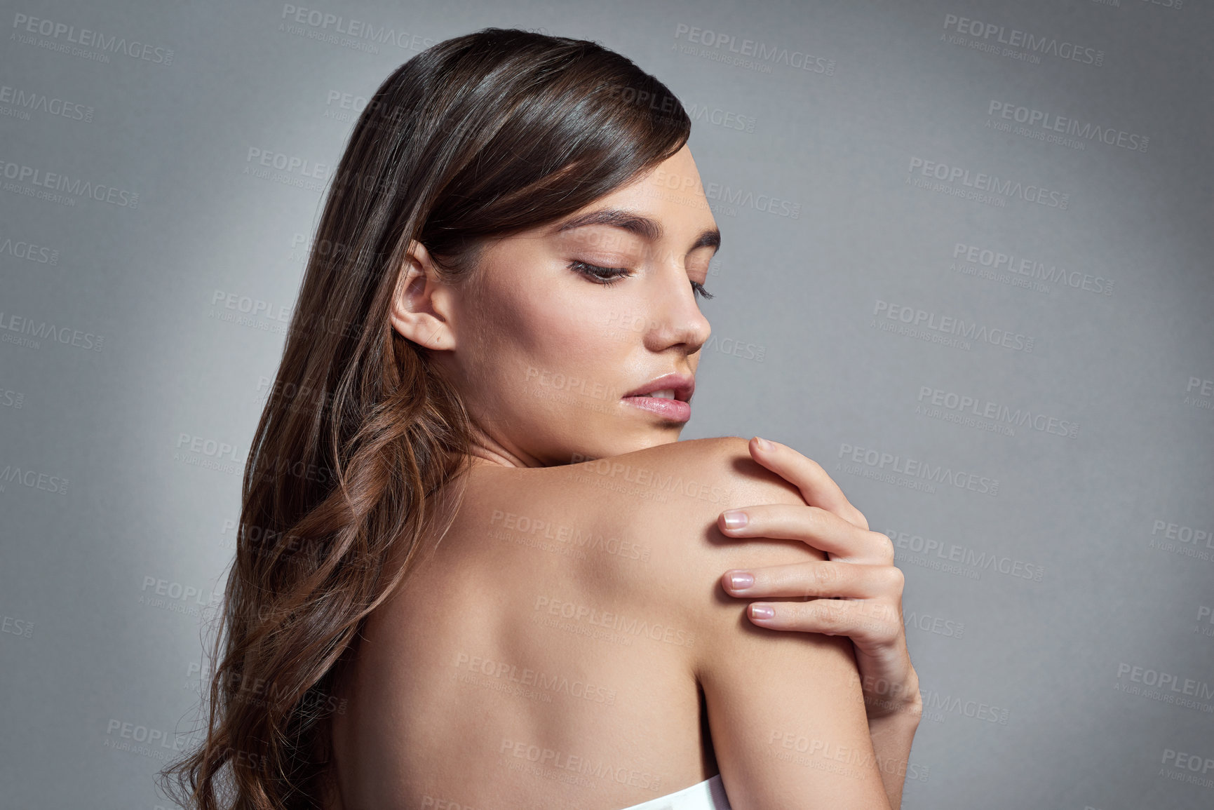 Buy stock photo Studio shot of a beautiful young woman posing against a gray background 