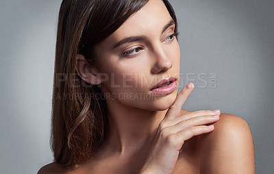 Buy stock photo Studio shot of a beautiful young woman posing against a gray background 