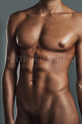 Buy stock photo Cropped studio shot of a muscular young man posing in the nude against a grey background