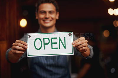 Buy stock photo Doorway, portrait and man with open sign for cafe, invite clients and coffee shop hours for customer service. Restaurant, male owner and board with message for hospitality, entrance or small business