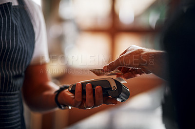 Buy stock photo Closeup of an unrecognizable person making a payment to a barman through use of a credit card inside a beer brewery during the day
