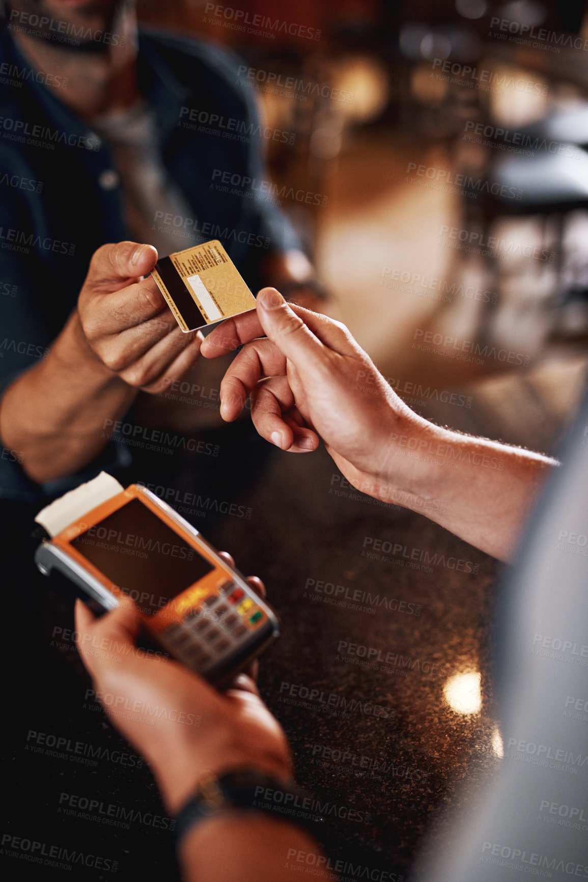 Buy stock photo Closeup of an unrecognizable person making a payment to a barman through use of a credit card inside a beer brewery during the day
