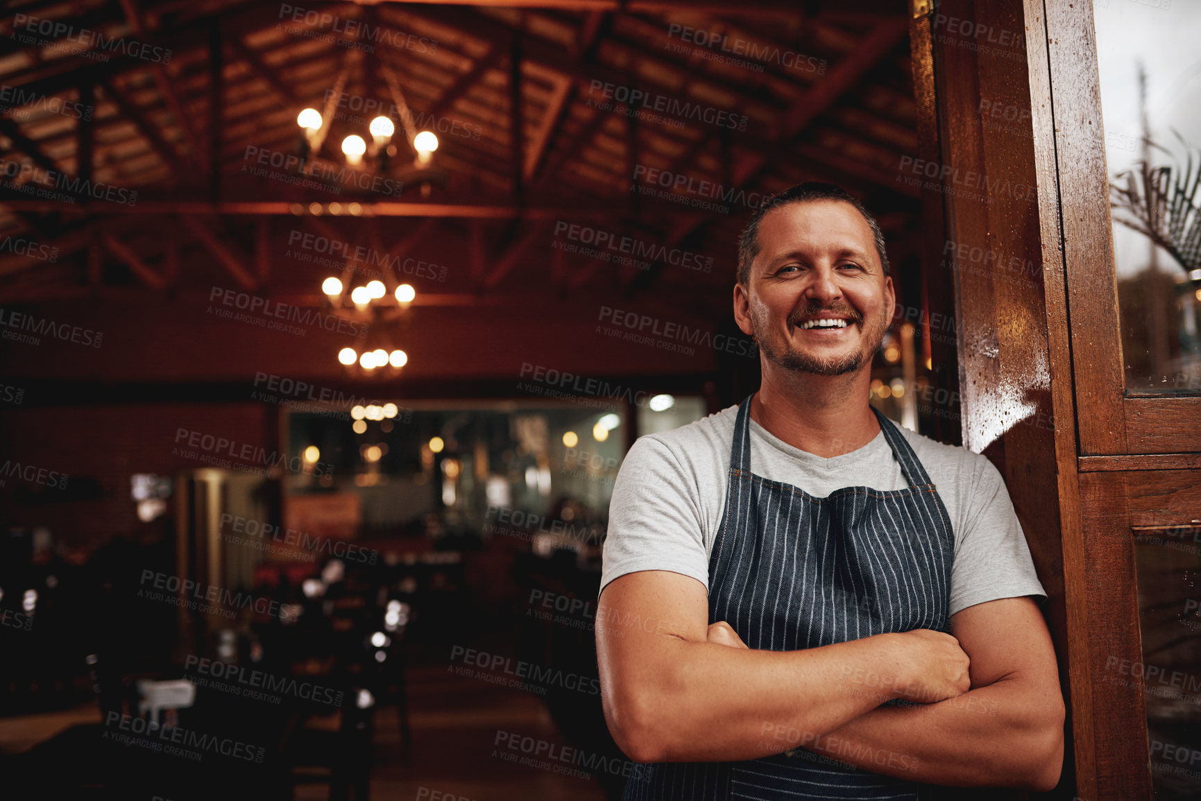Buy stock photo Happy man, portrait and small business owner of restaurant, cafe or pub with a smile for career pride. Male entrepreneur person as manager, barista and waiter at door for shop welcome greeting