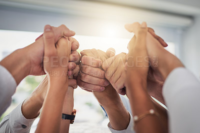 Buy stock photo Cropped shot of a group of businesspeople holding their hands in solidarity