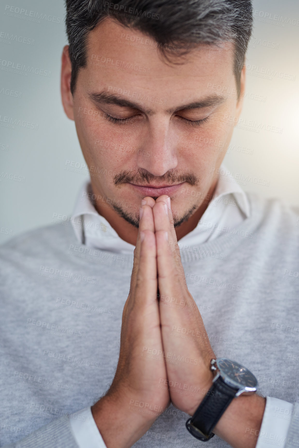 Buy stock photo Shot of a young businessman praying
