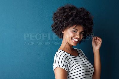 Buy stock photo Girl, portrait and pull afro in studio with mockup space for growth, results or smile by blue background. African person, woman and model with curly hair care, happy and transformation with cosmetics