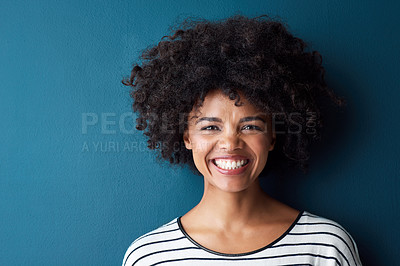 Buy stock photo Black woman, portrait and smile with funny, glow and confident on blue studio background. Girl, model and face with afro laughing for joke, comic and happiness or positive with natural beauty