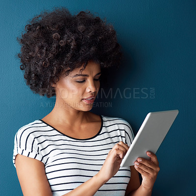 Buy stock photo Female student, tablet and social media in studio for research, online at university for education. Woman, ebook and blue background with application for email, check for class schedule in Kenya