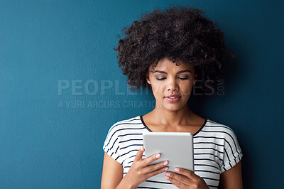 Buy stock photo African woman, tablet and space in studio for mockup with reading on app, study or quiz by blue background. Person, girl and student with digital touchscreen, online course or elearning for education