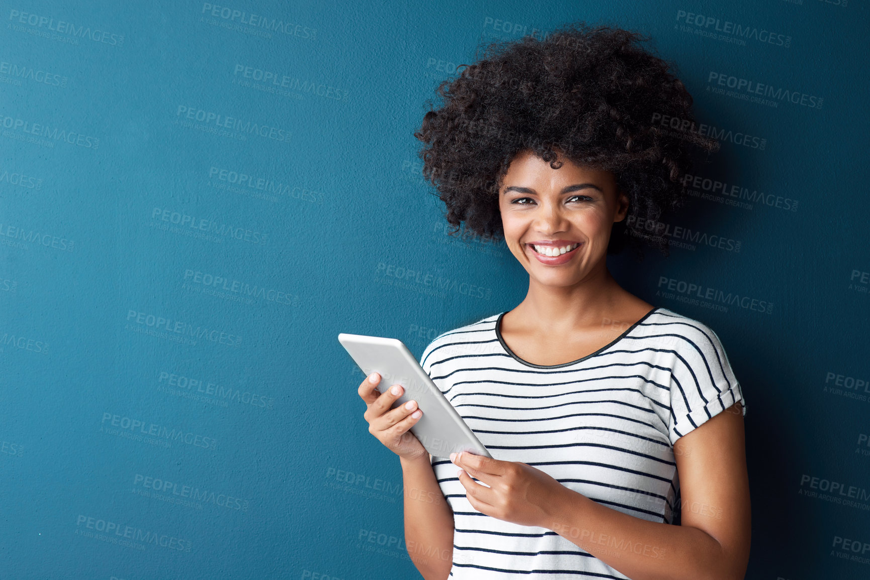 Buy stock photo African woman, tablet and smile in studio portrait with space for mock up with study on app by blue background. Person, girl and click on digital touchscreen, online course or elearning for education