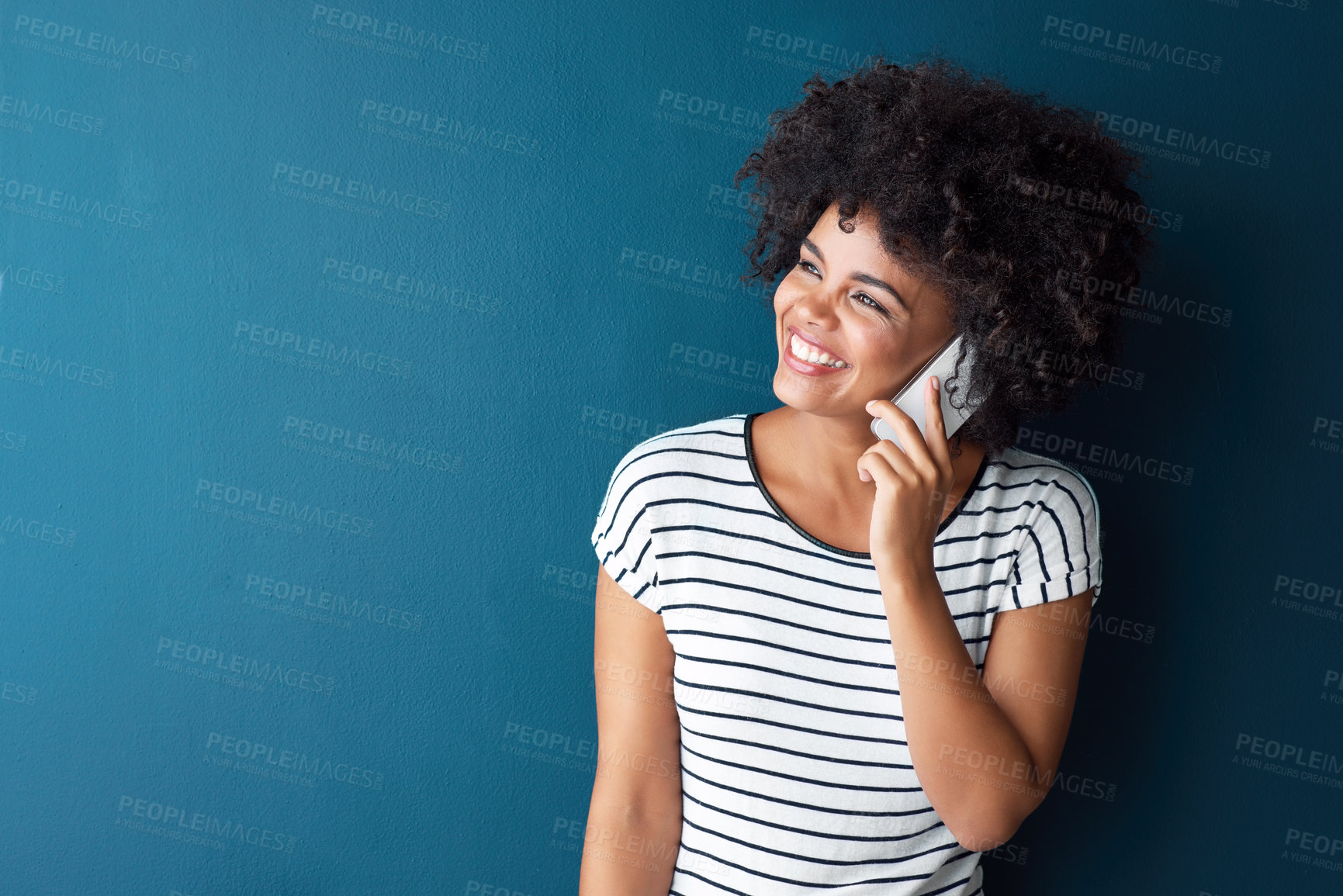 Buy stock photo African woman, phone call and smile in studio by space for mockup, thinking or contact by blue background. Person, girl and smartphone with conversation, listening or happy for chat on mobile network