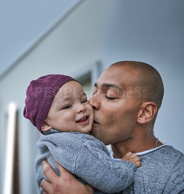 Buy stock photo Love, father or kiss baby on cheek in home with bonding, affection or protection with security, support or care. Family, man and boy child with smile for connection, relax together or cuddle in house