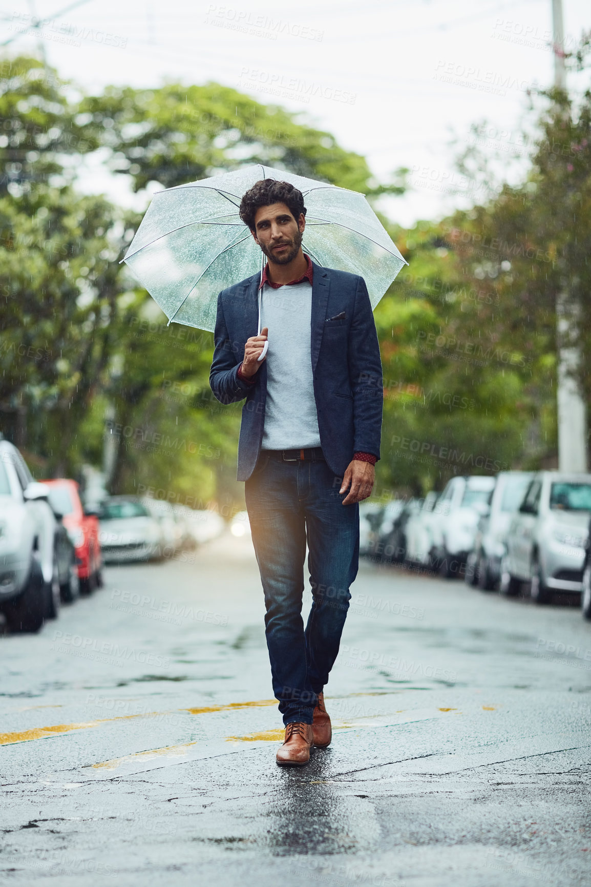 Buy stock photo Full length shot of a handsome young businessman on his morning commute in the rain