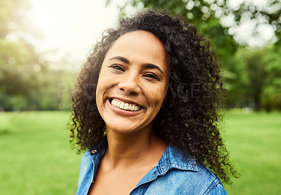 Buy stock photo Portrait of a beautiful young woman in a public park