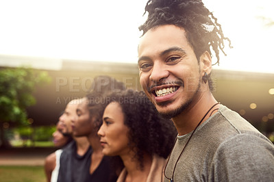 Buy stock photo Cropped shot of a group of friends standing in a row in a public park