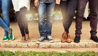Buy stock photo Cropped shot of a group of unrecognizable people standing in a row in a public park