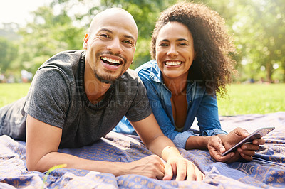 Buy stock photo Cropped shot of a young beautiful couple spending the day in a public park