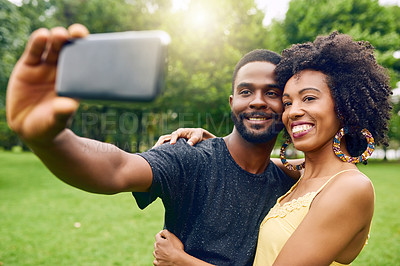 Buy stock photo Outdoor, black couple and hug with selfie for picture, photography and memory together in relationship. Park, man and woman with love for commitment, dating and bonding with happiness in nature