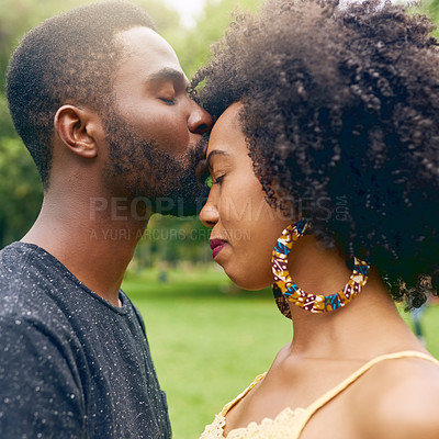Buy stock photo Cropped shot of an affectionate young couple spending some time together in the park