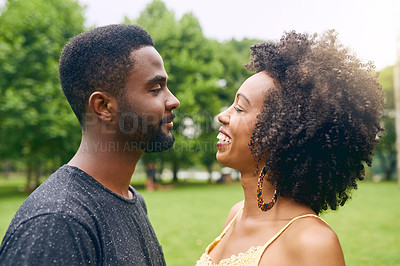 Buy stock photo Cropped shot of an affectionate young couple spending some time together in the park