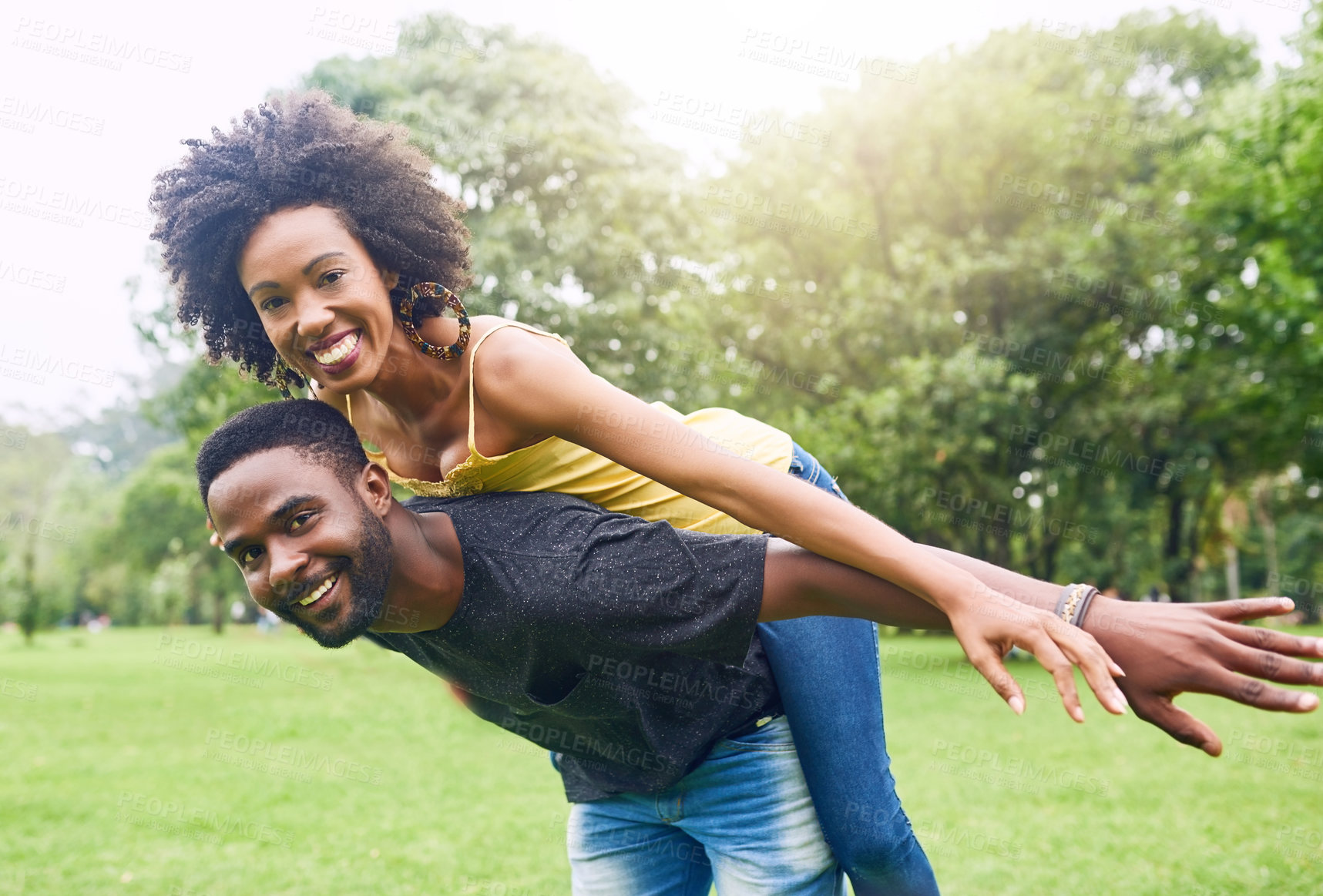 Buy stock photo Black couple, park and smile with piggyback for romantic date and picnic in Brazil. People, relationship and outdoor on portrait for fun with support or care on break to relax , rest and love