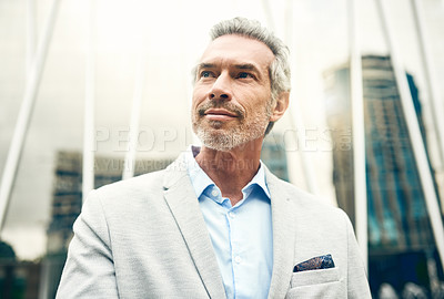 Buy stock photo Shot of a mature businessman out in the city