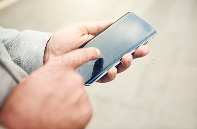 Buy stock photo Closeup shot of an unrecognizable businessman using a cellphone outdoors