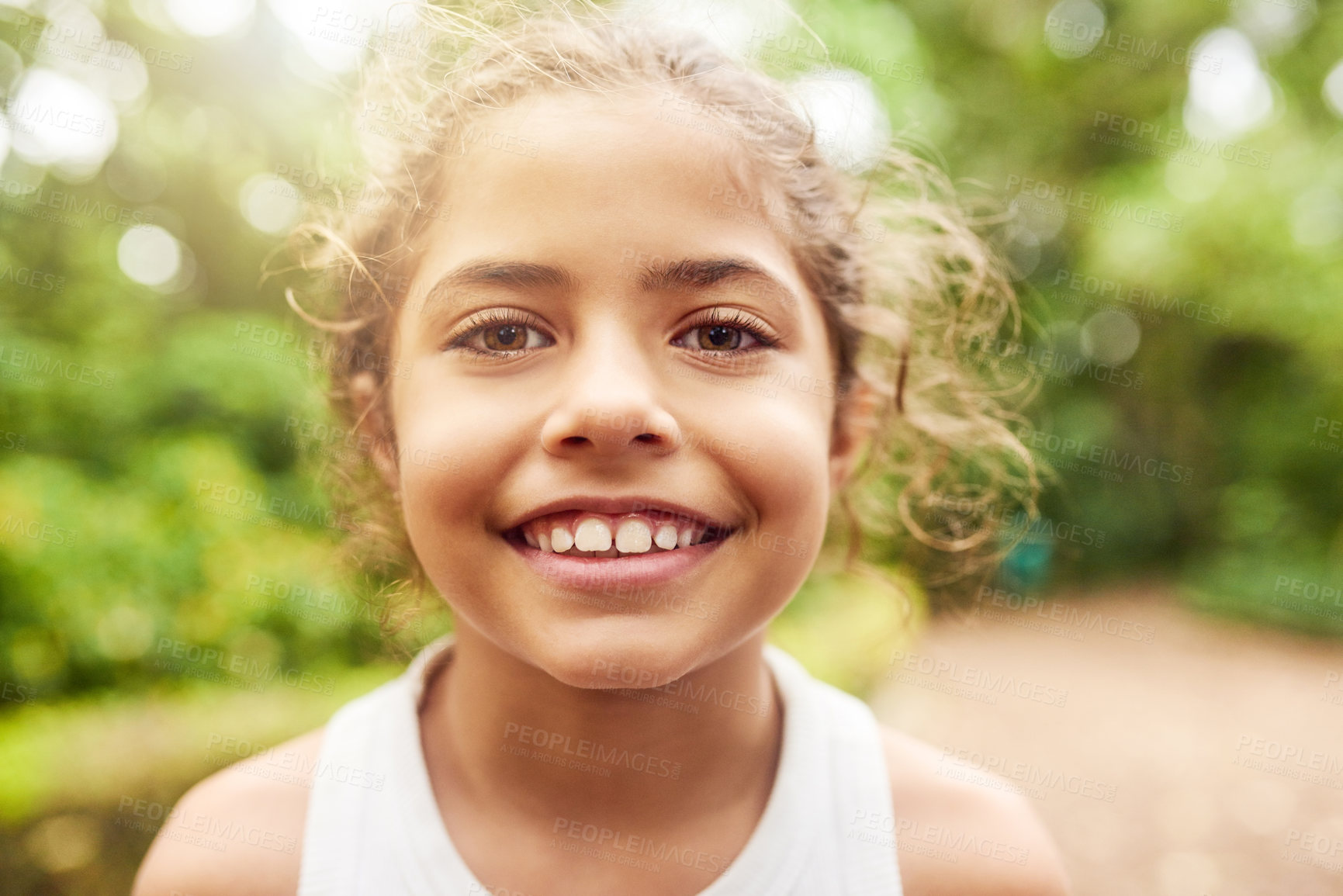 Buy stock photo Cropped portrait of an adorable little girl standing outside in the park